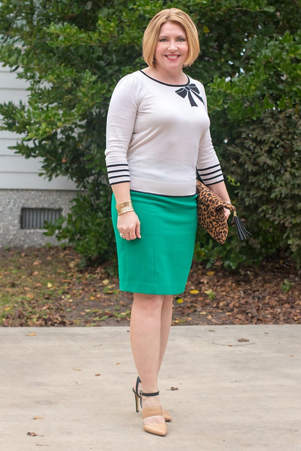 bow sweater and green pencil skirt Christmas outfits that aren't red and black
