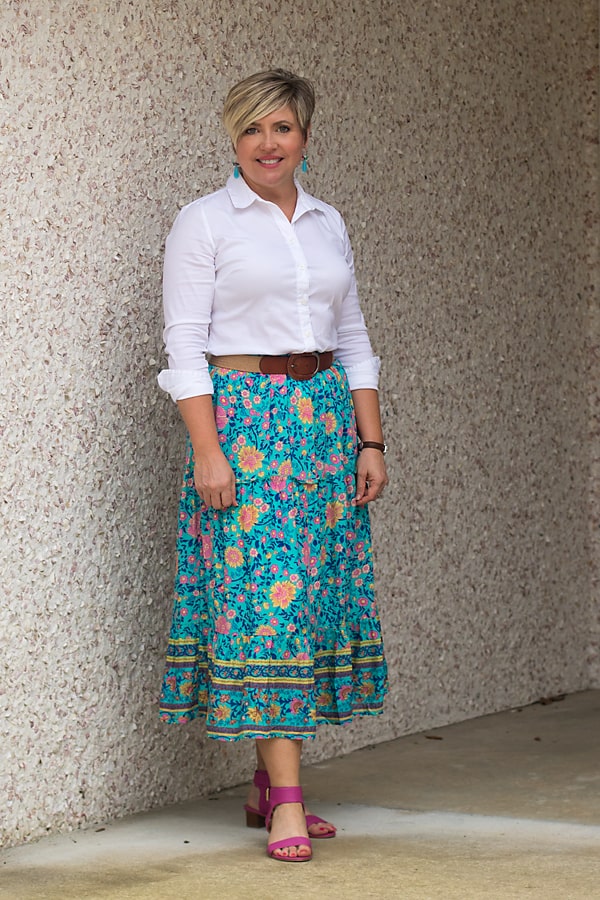 Wear a midi skirt with a white button up and wide belt. 