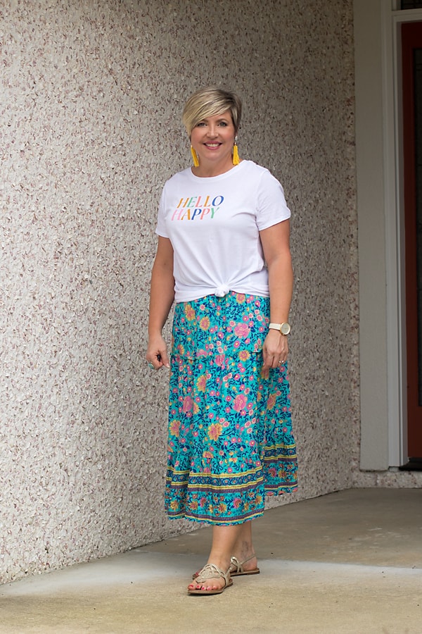 Wear a midi skirt with a knotted graphic tee.