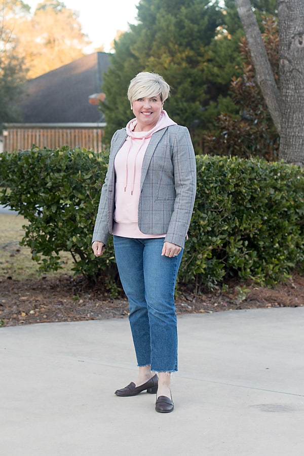 blogger wearing casual plaid blazer outfit with hoodie, joggers