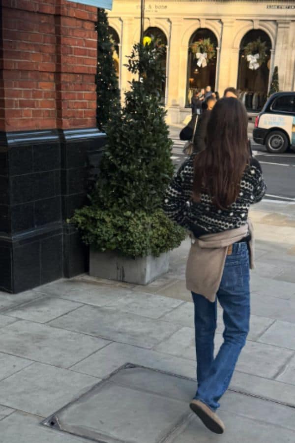 woman wearing a sweater tied around waist