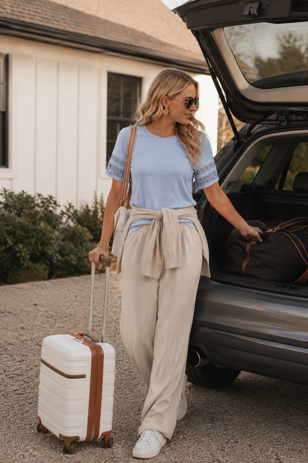 woman in linen pants travel day outfit loading car for vacation